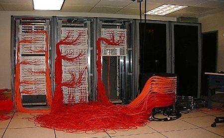 Server racks overflowing with red ethernet cables